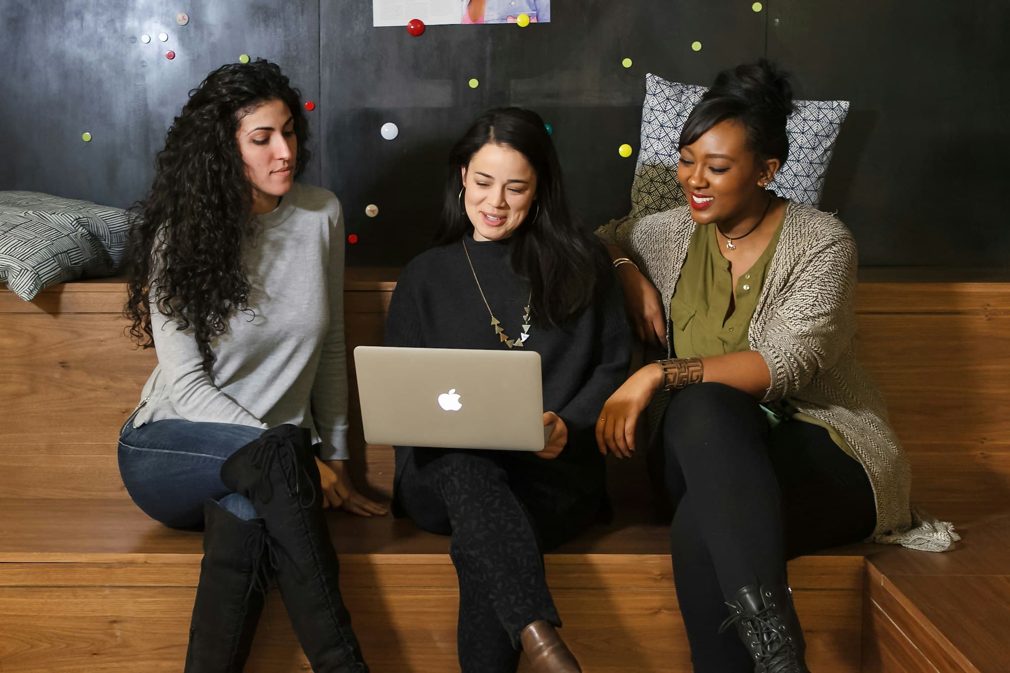 A young startup team gathered around a laptop